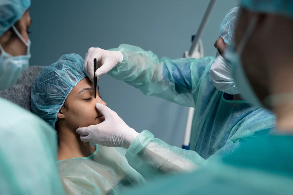 Doctor checking patient before open vs closed rhinoplasty.