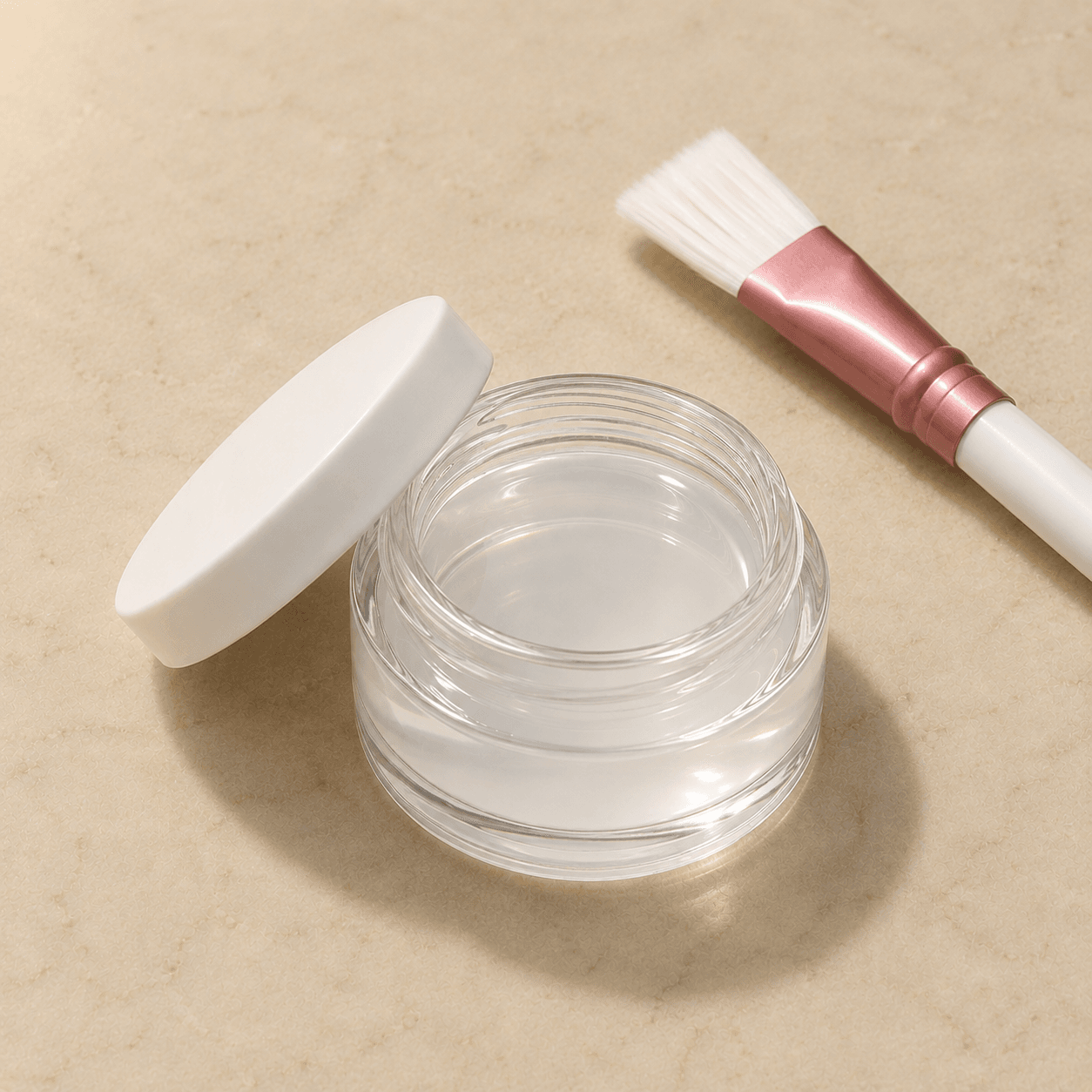 Isometric shot of a glass jar of clear ArgiPeel solution with a faint white tint, lid resting beside it, with a clinical brush accented in dusty rose.