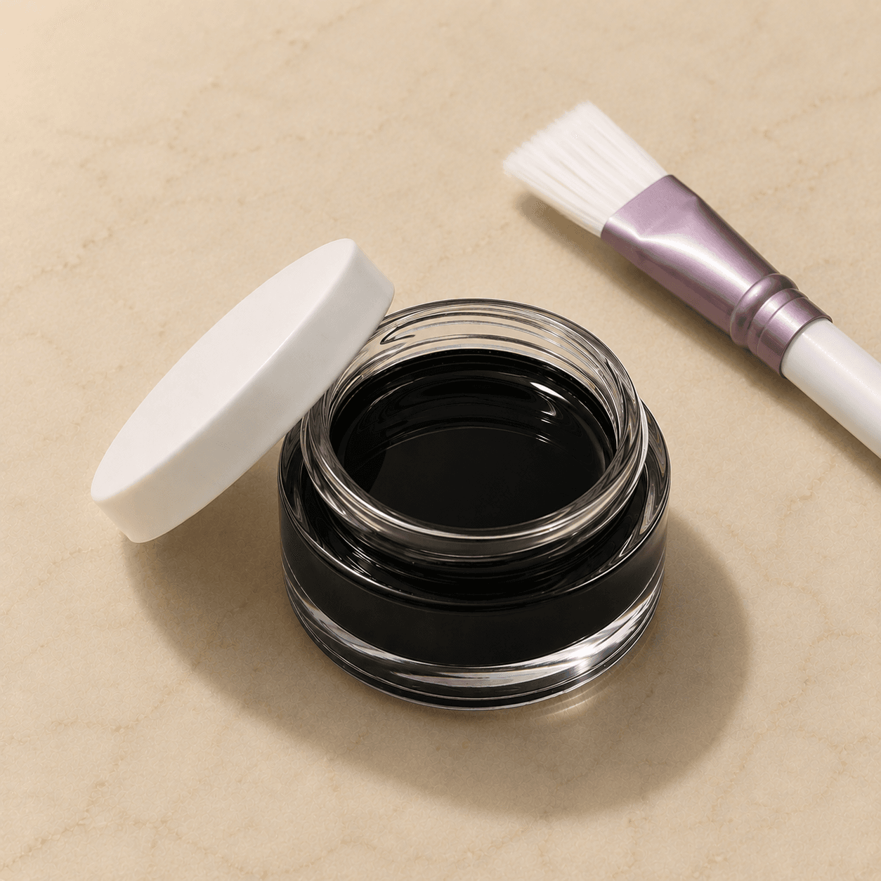Isometric shot of a glass jar of glossy black peel solution, lid resting beside it, with a clinical brush accented in dusty lavender.